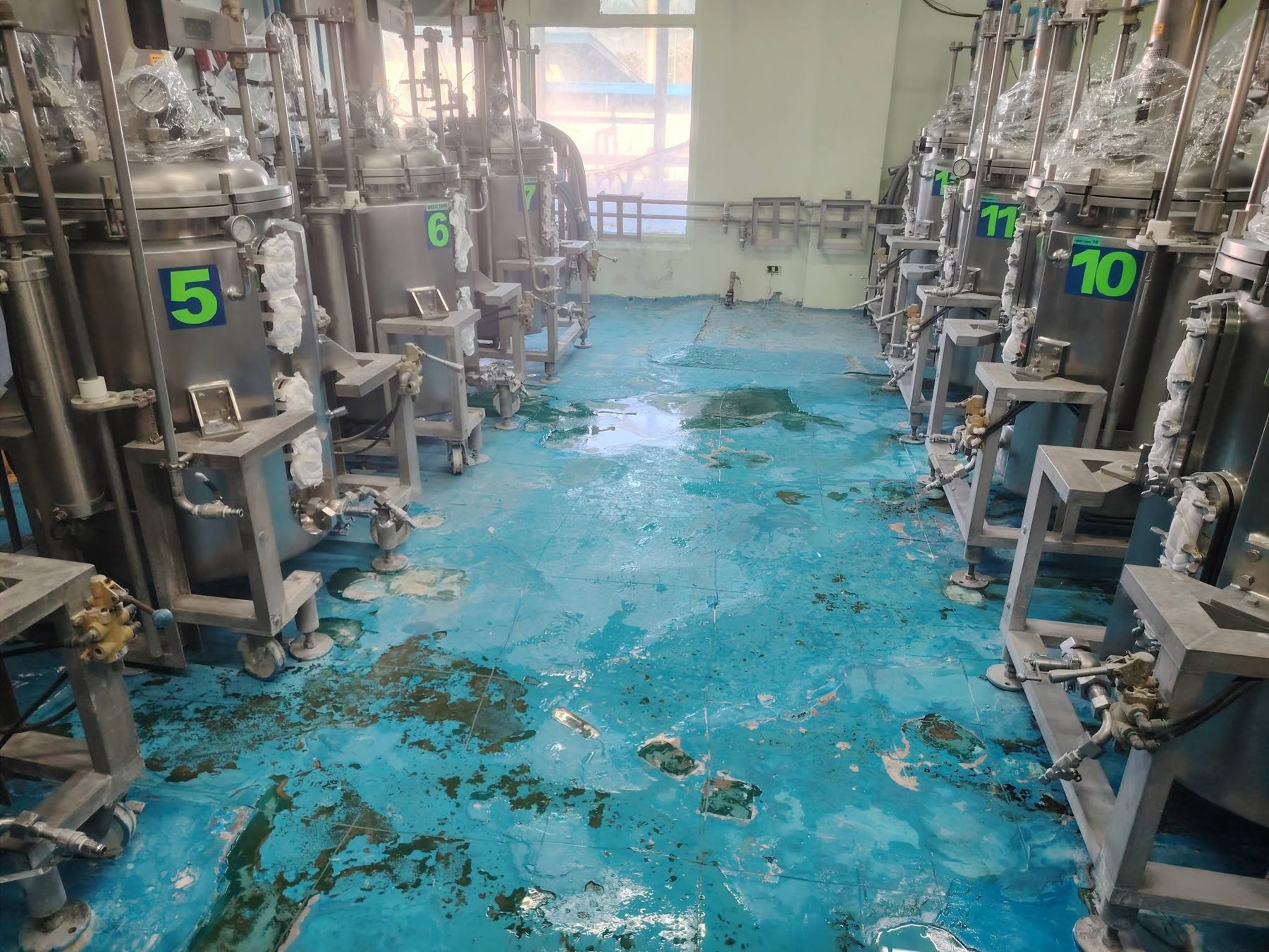 Blue worn industrial floor before resurfacing