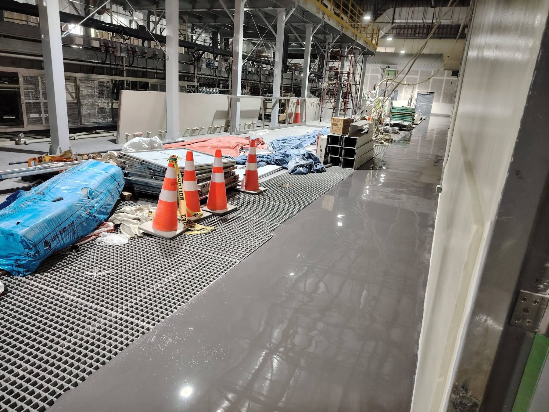 Glossy gray epoxy floor during industrial site work